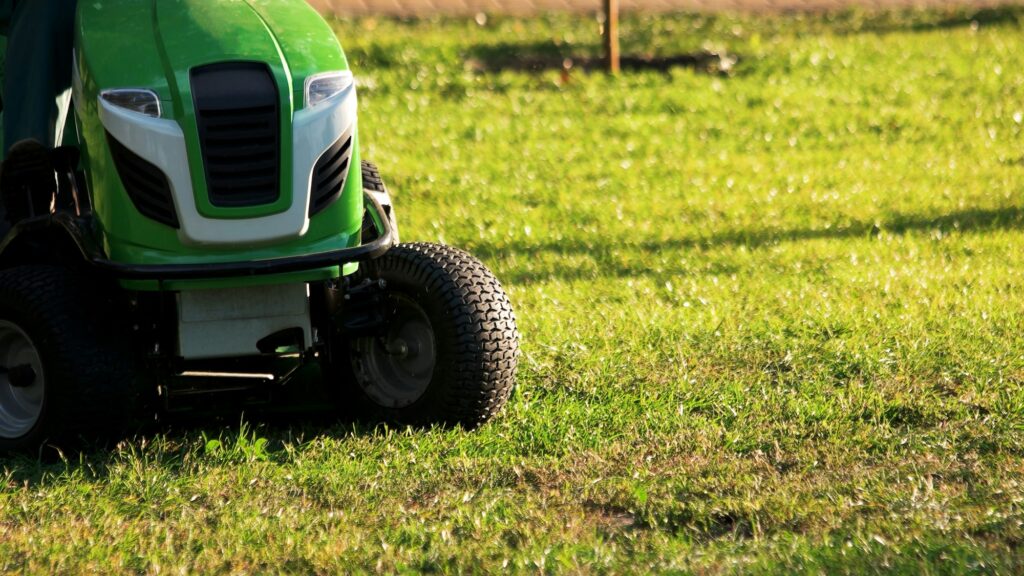 Green lawn mower tractor.